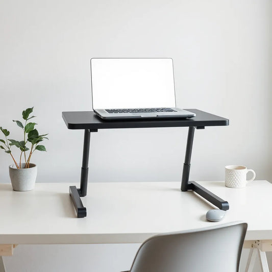 Adjustable laptop table stand holding an open laptop on a minimalist desk.